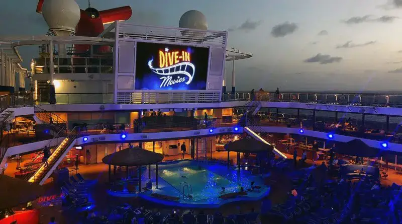 Night-time dive-in theater showing on a movie screen on the Carnival Vista