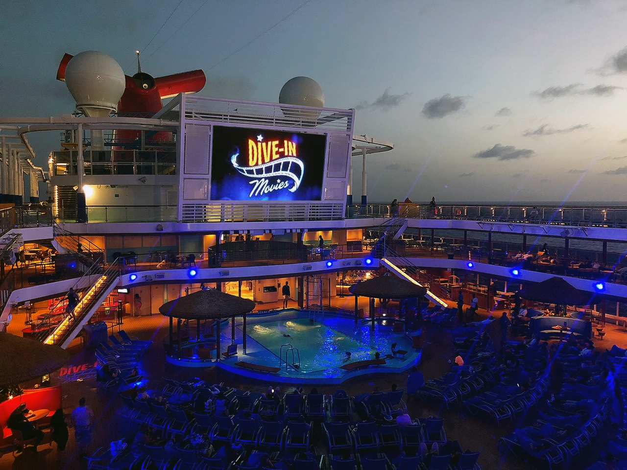 Night-time dive-in theater showing on a movie screen on the Carnival Vista