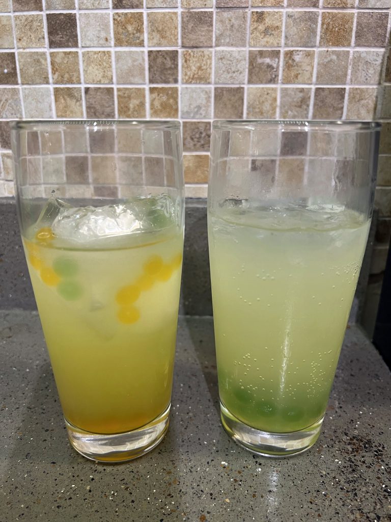 2 cocktails on counter with boba pearl