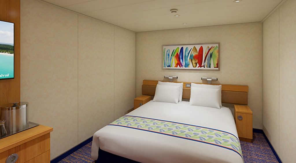 king bed in interior cabin on the Carnival Sunrise