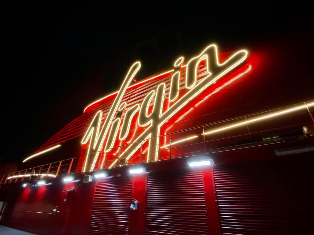 Virgin Voyages sign at night on Scarlet Lady Cruise Ship