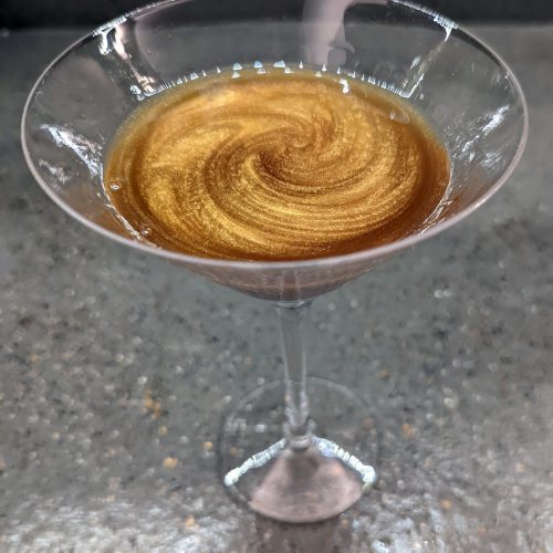 cocktail with gold swirl in it