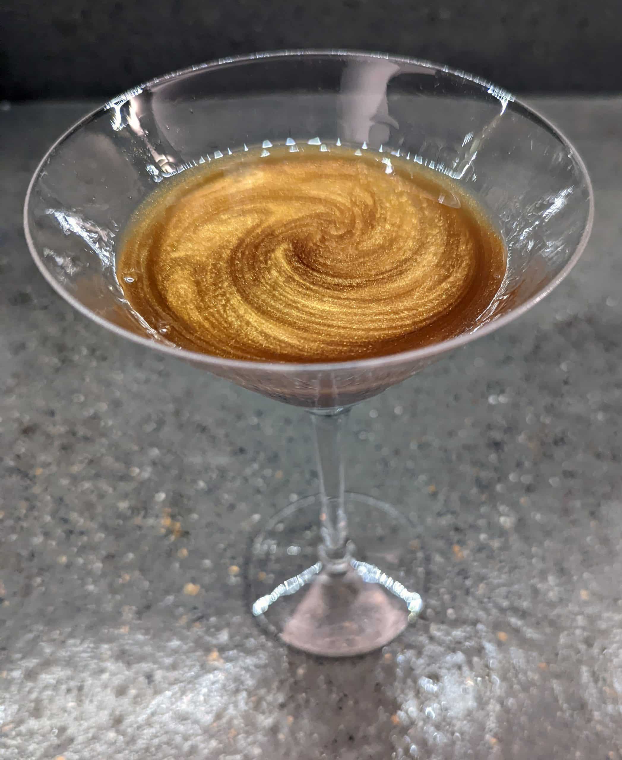 cocktail with gold swirl in it
