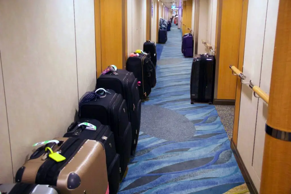 cruise ship hallway with suitcases
