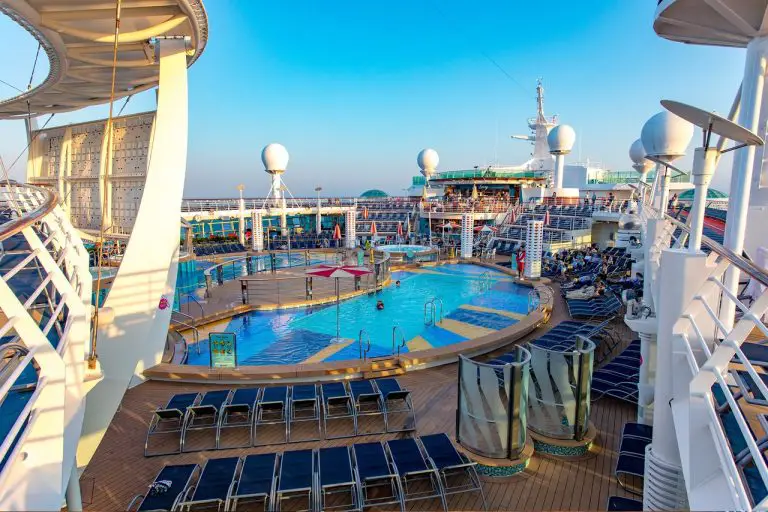 The main pool deck with two pools and lounge chairs on Royal Caribbean