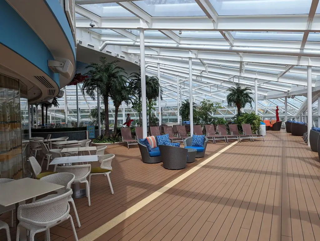 seating areas in solarium on ovation of the seas
