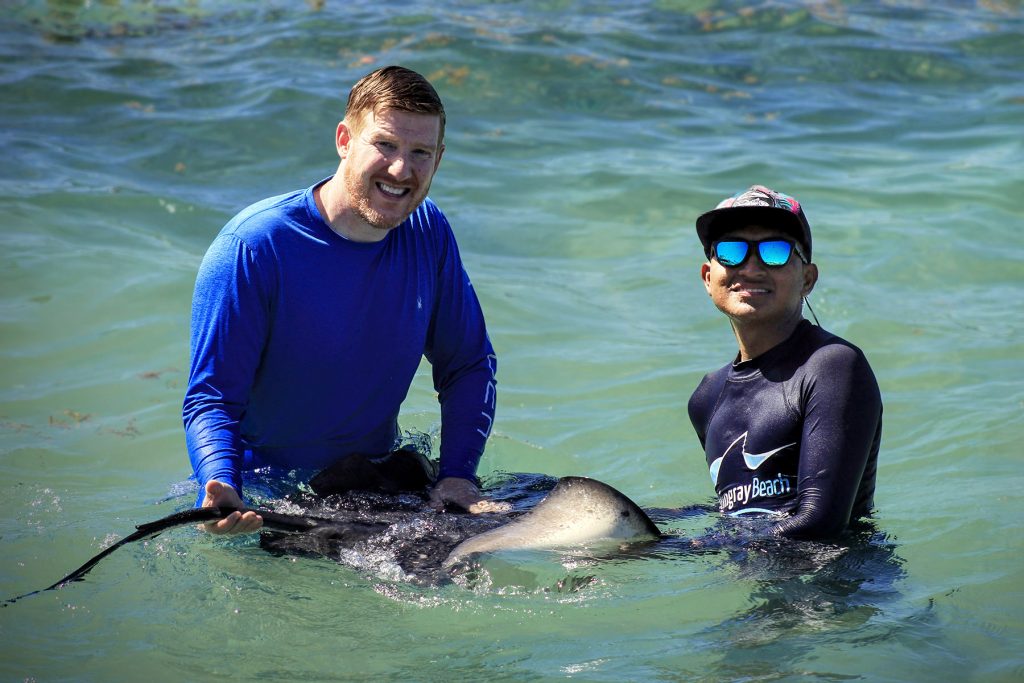 stingray beaching holding a stingray