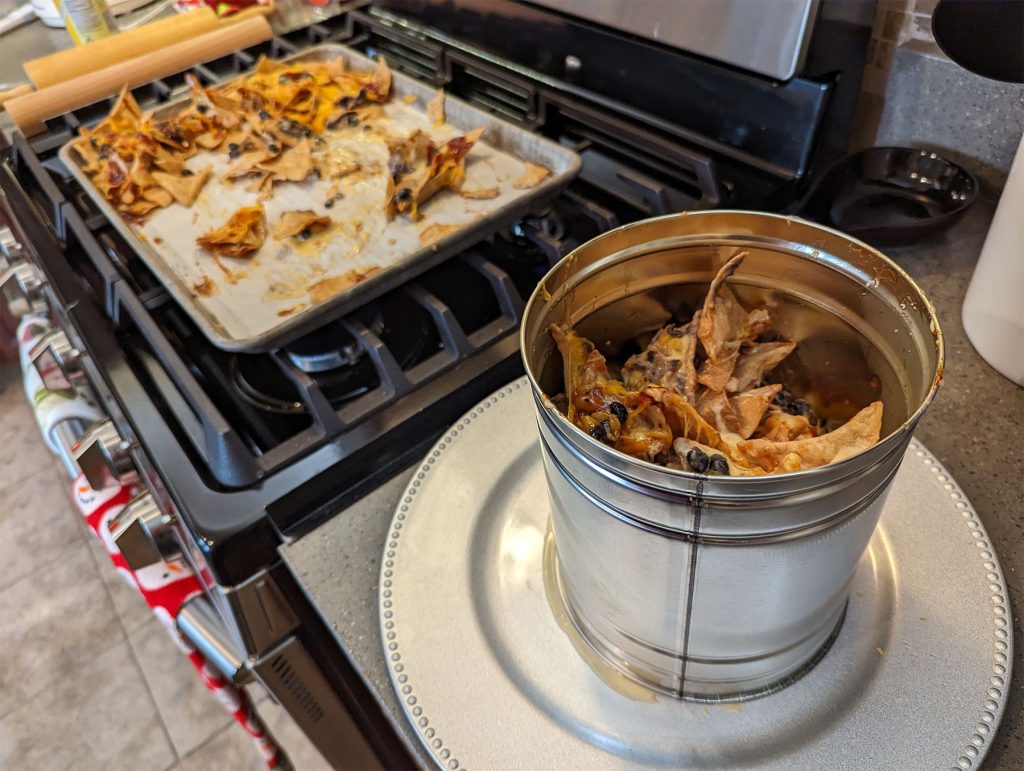 nachos being assembled into a tower