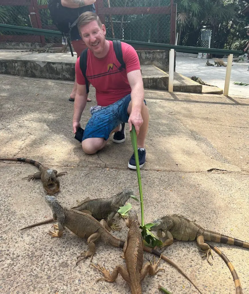 randy young with iguanas in Roatan, Honduras