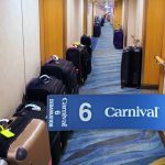 hallway with suitcases and carnival luggage tag