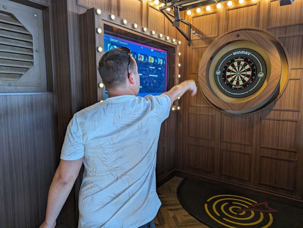 man throwing dart at bulleyes dart lounge