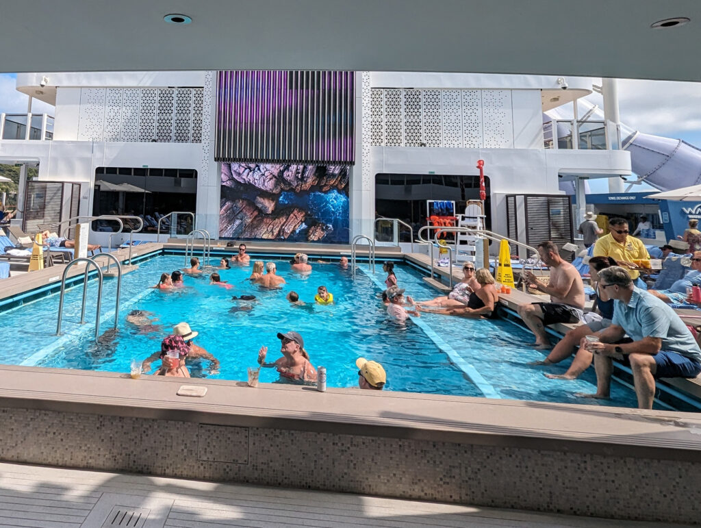 norwegian viva main pool with people in it