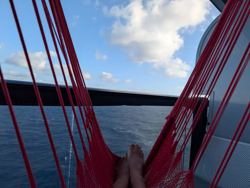 laying on red hammock with ocean view on cruise ship