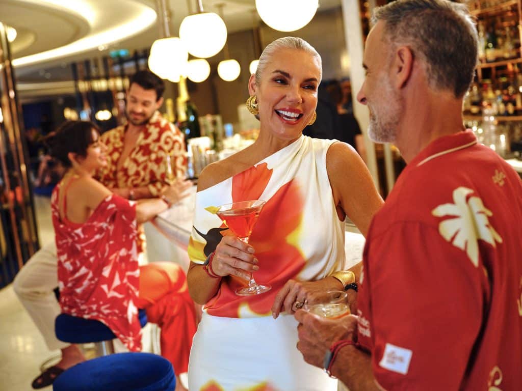 couple at a bar with cocktail on virgin voyages