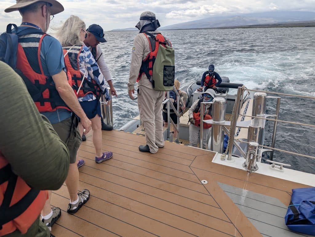 group of people boarding tender on celebrity flora