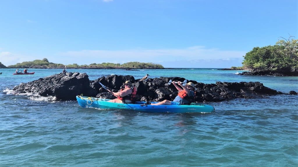 kayak in galapagos by rocks